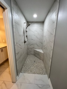 A curbless shower, with an ornate shower head