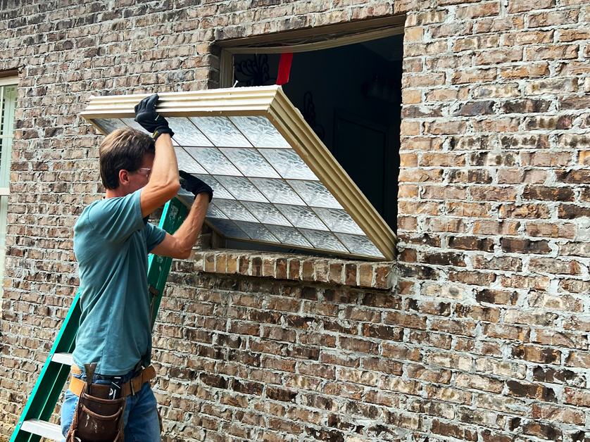 Exterior Renovations project, installing a window