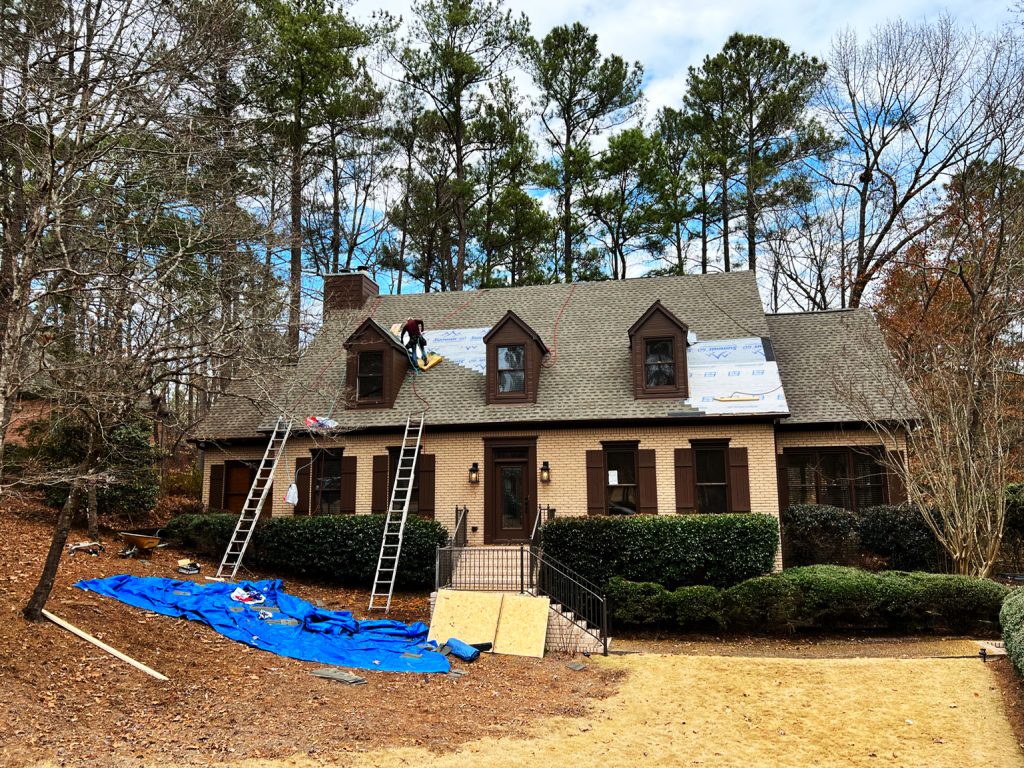 A man working on a roof, one of the great fall remodeling ideas.